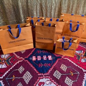 Six Louis Vuitton shopping bags
